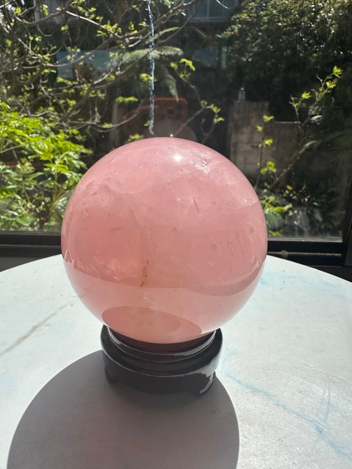 Unedited natural-light photo of exact rose quartz sphere #2, 1.42kg, 10.3cm / approximately 4.06 inches