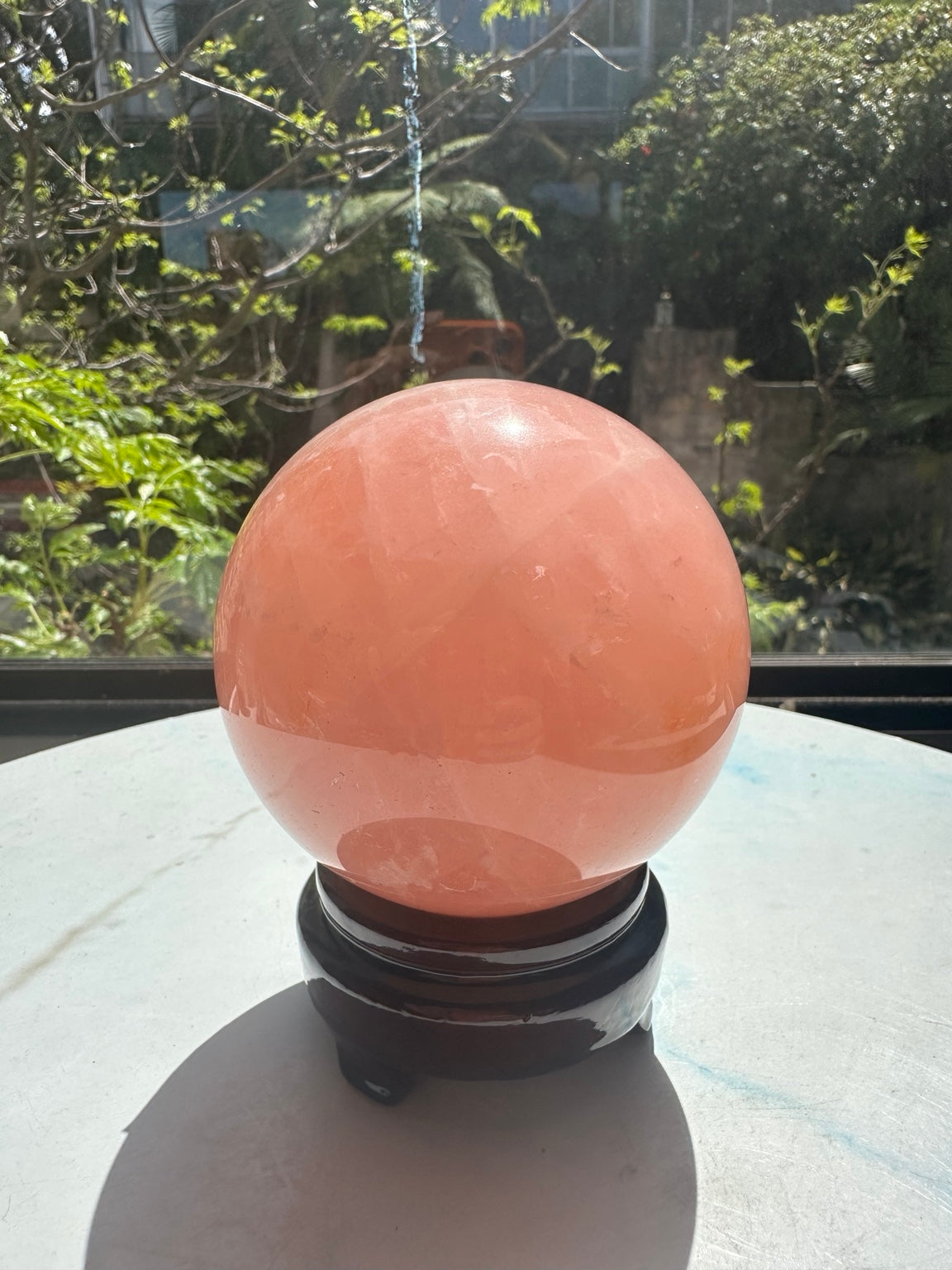Unedited natural-light photograph of exact Madagascar rose quartz sphere #4 with stand, 936g, 9cm / approximately 3.54 inches
