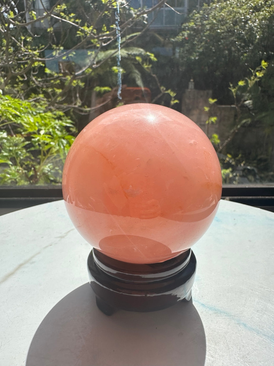 Unedited natural-light photograph of exact Madagascar rose quartz sphere #4 with stand, 936g, 9cm / approximately 3.54 inches