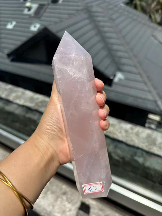 Madagascar rose quartz tower 716g shown in hand, front view of exact piece #3