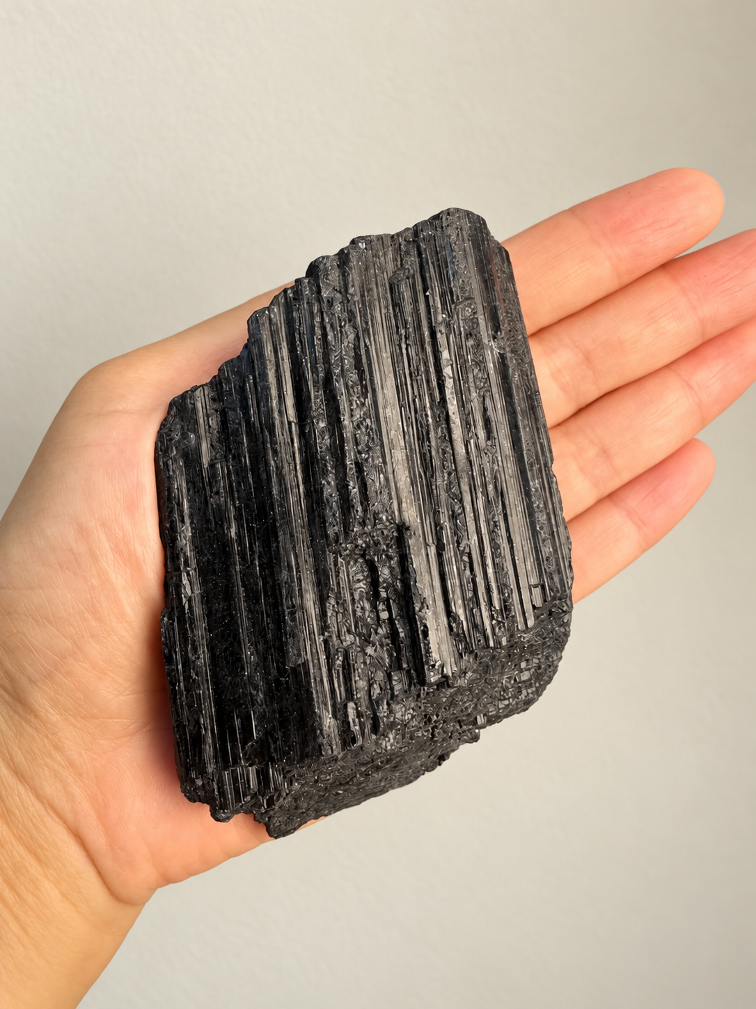 Large Raw Black Tourmaline Chunk, detailed view 2 in soft indoor light.