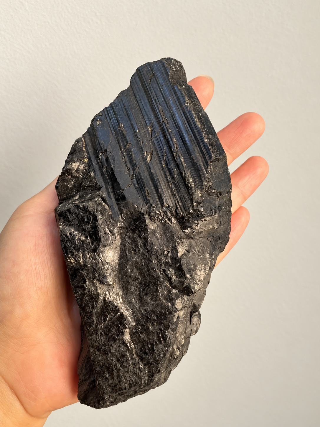 Large Raw Black Tourmaline Chunk, detailed view 3 in soft indoor light.