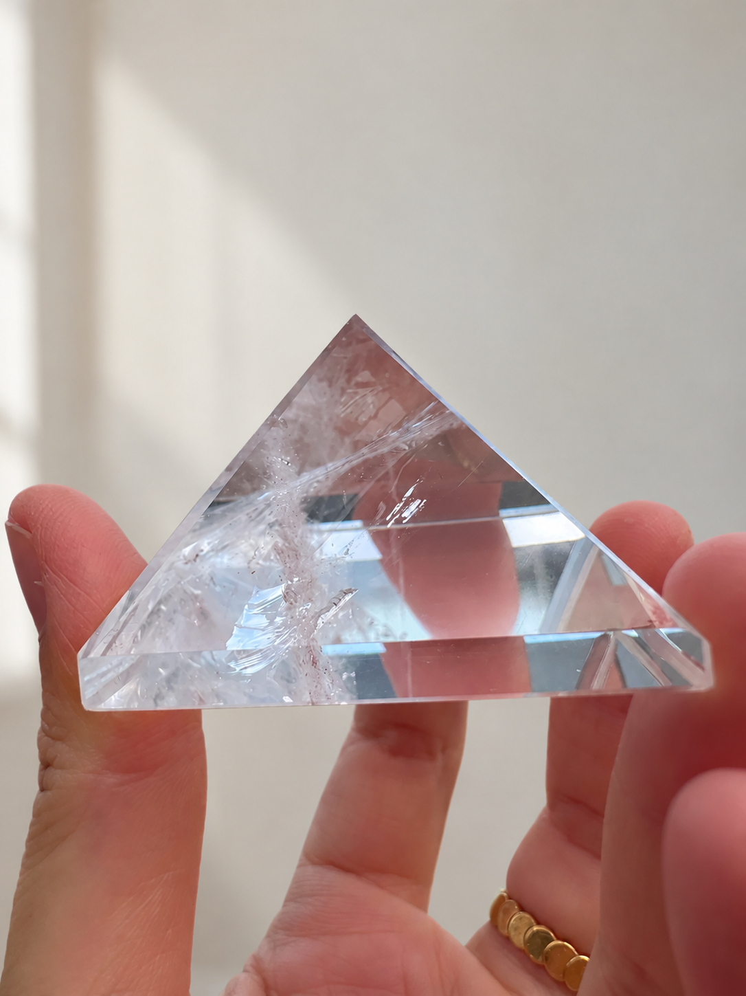 Natural Clear Quartz Pyramid, detailed view 3 in soft indoor light.