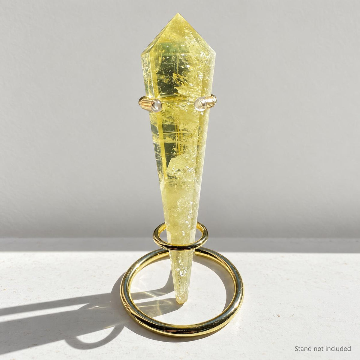 Citrine crystal wand in soft indoor light.