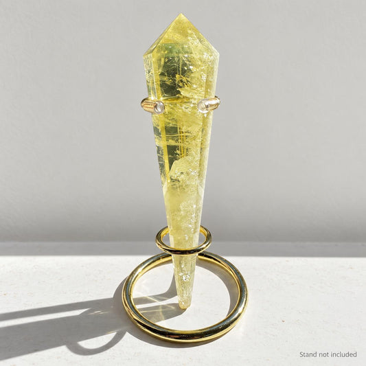 Citrine crystal wand in soft indoor light.