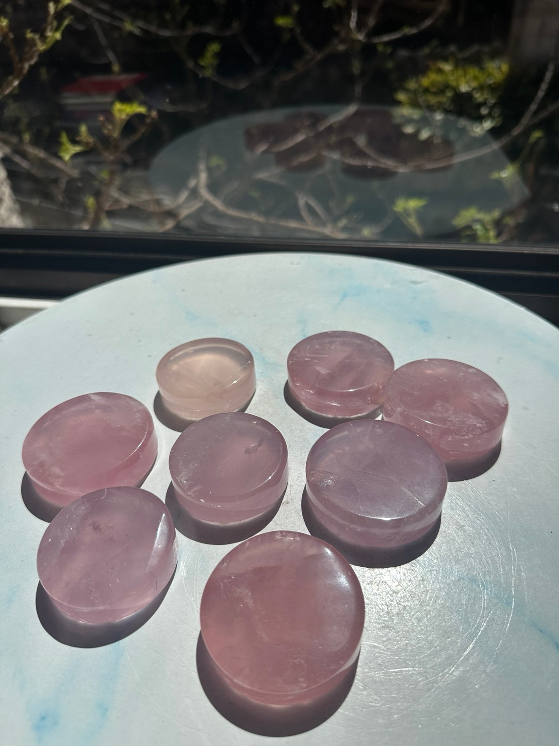 Original natural daylight photograph of rose quartz mini dishes showing individual pink colour variation