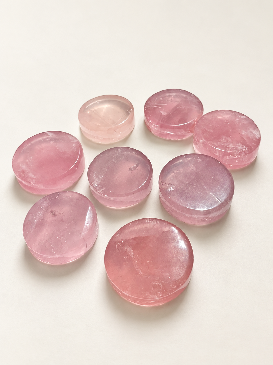 Assortment of rose quartz crystal dishes showing individual tones and natural variation