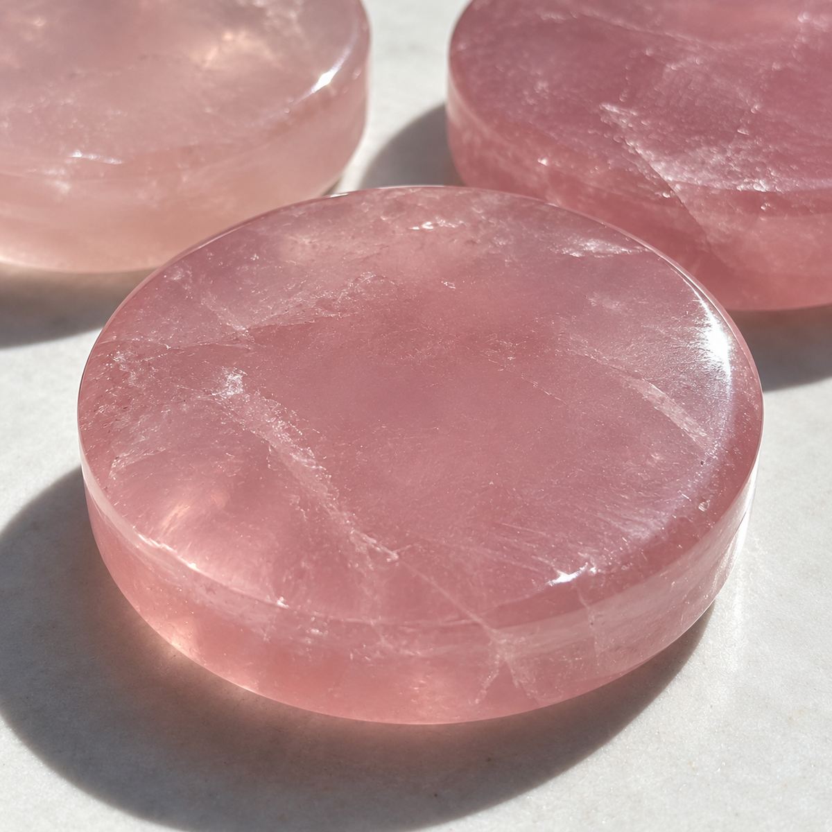 Close-up of rose quartz shallow dish rim, polished surface and visible thickness