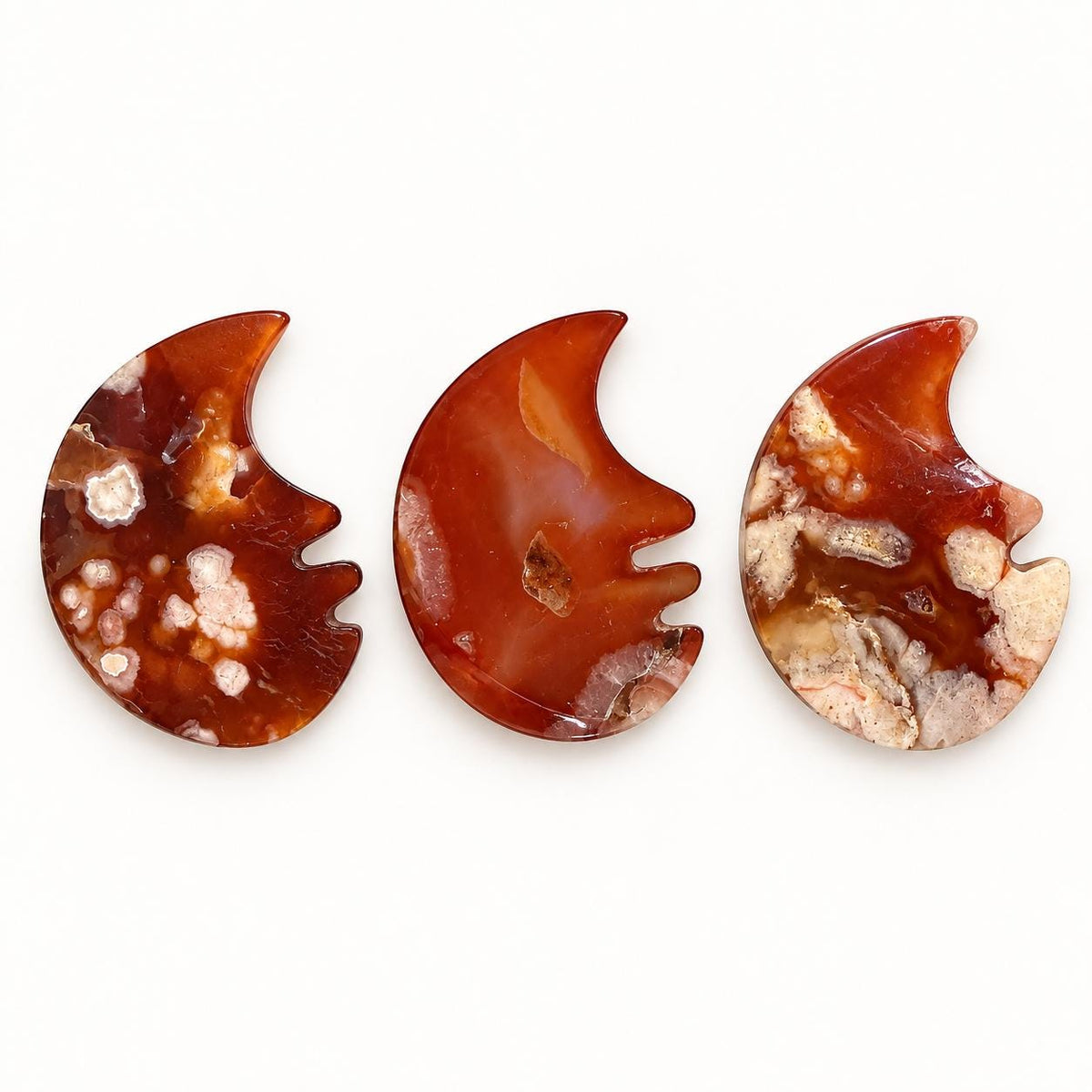 Polished red agate moon face carving from Madagascar, approximately 4 to 5cm