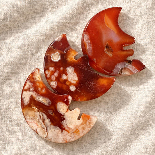 Red agate smiling crescent moon crystal carving with natural patterns, approximately 4 to 5cm
