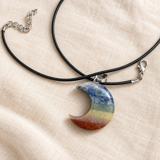 Seven chakra crescent moon crystal necklace with rainbow gemstone bands and black cord, approximately 3.5cm