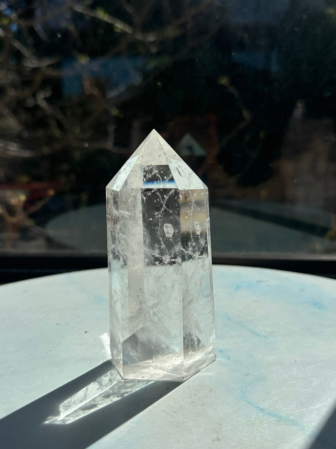 Rear face of clear quartz tower #5 showing internal fracture patterns and polished point