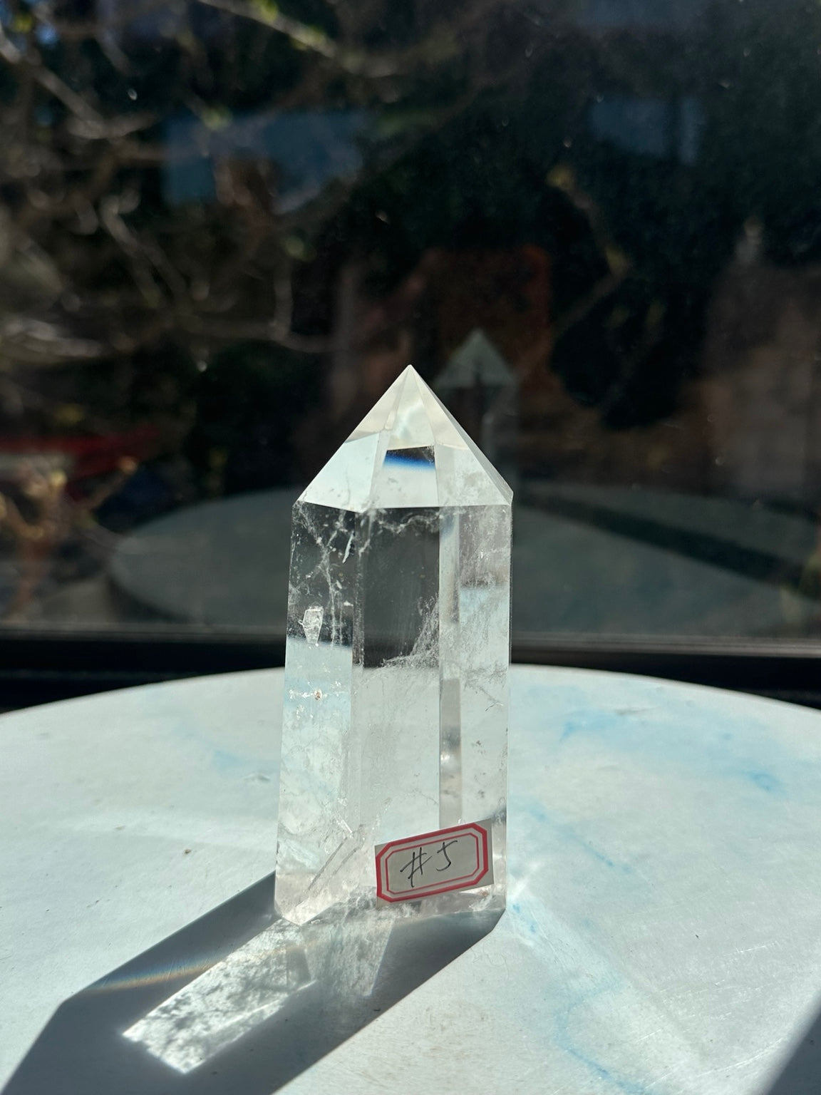 Angled view of quartz tower #5 showing natural internal textures and polished edges