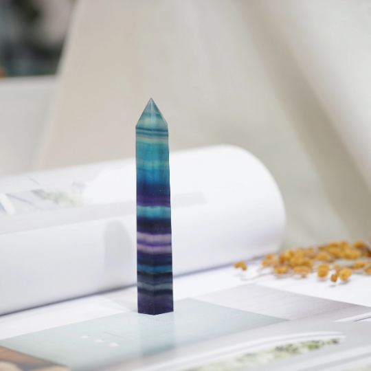 Polished Rainbow Fluorite crystal tower showing layered purple-green bands